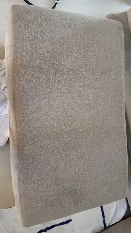Seat cushion partway through cleaning with the stains lifted