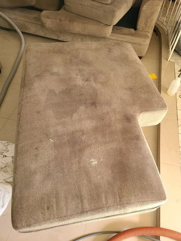 Soiled sectional chaise cushion before cleaning