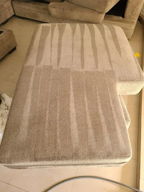 Sectional chaise mid-clean, lighter steam passes striped across the fabric